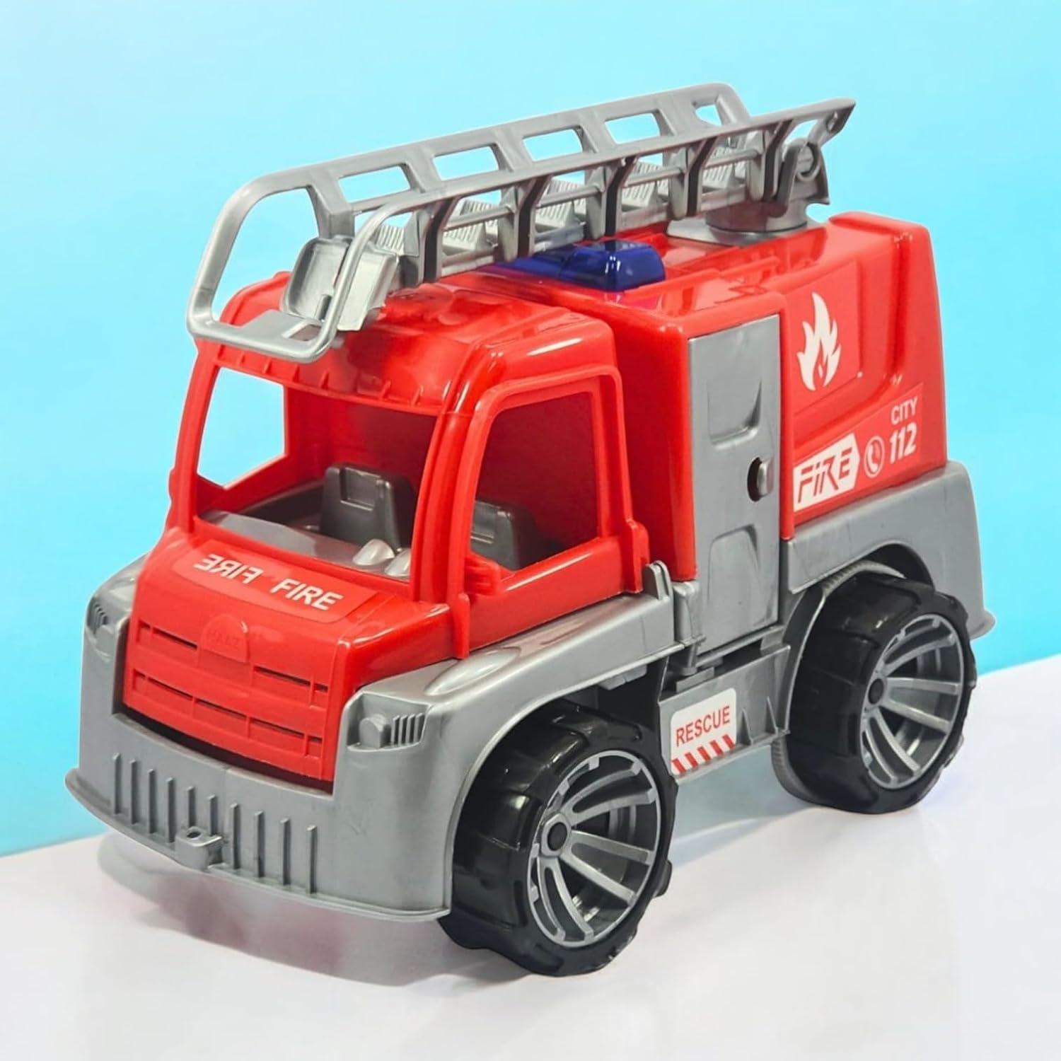 Toy fire truck with red and gray colors on a light blue background