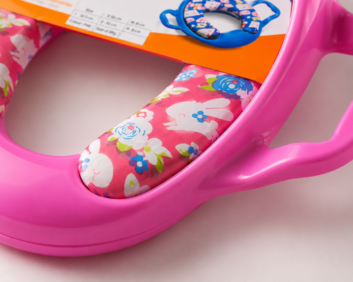 Close-up view of soft bunny print cushion and ergonomic handles on Honey Bee potty training seat