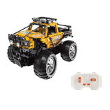 Toy monster truck with large wheels and a remote control on a white background