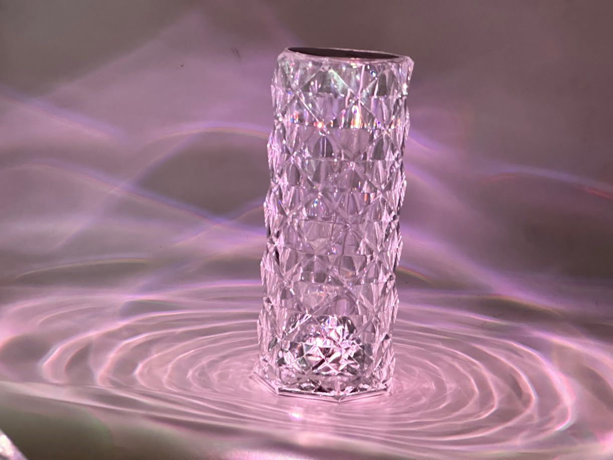 Crystal vase on a reflective surface with concentric circles