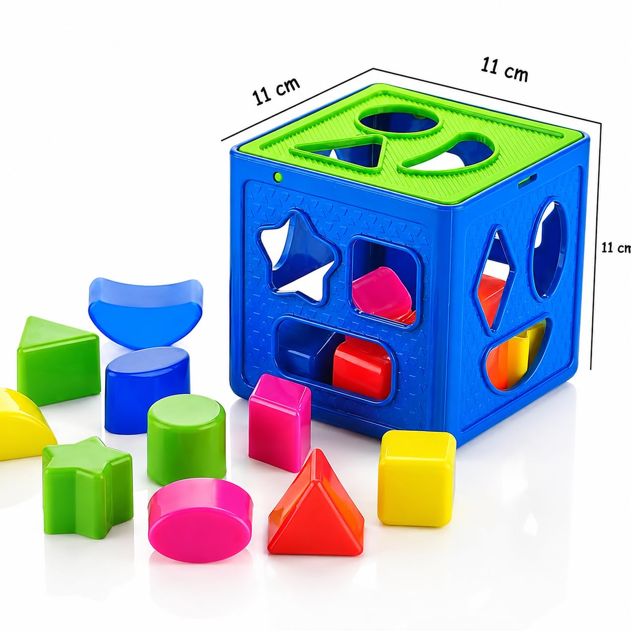 A children's shape-sorting cube toy in bright blue and green, shown with colorful geometric blocks on a white background. Black dimension lines and text indicate 11 cm measurements on the cube sides.